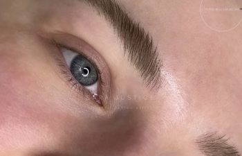 Close-up images showing a person's eyes and eyebrows before and after eyebrow enhancement, highlighting fuller, defined brows.